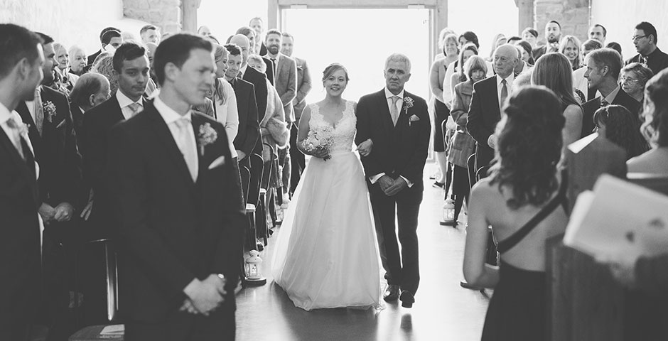 Bride and her father walk down the aisle