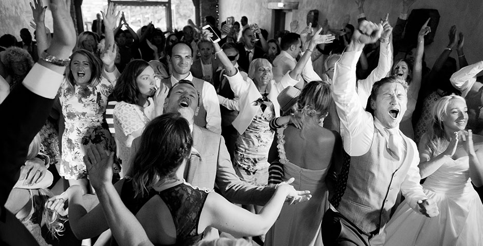 Whole wedding party dancing on the dancefloor