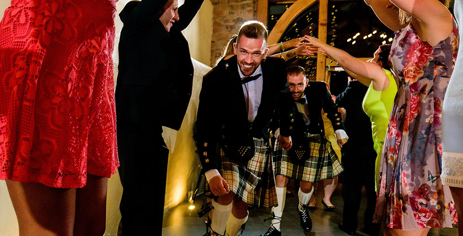 Groom and Groom dancing through the archway or arms
