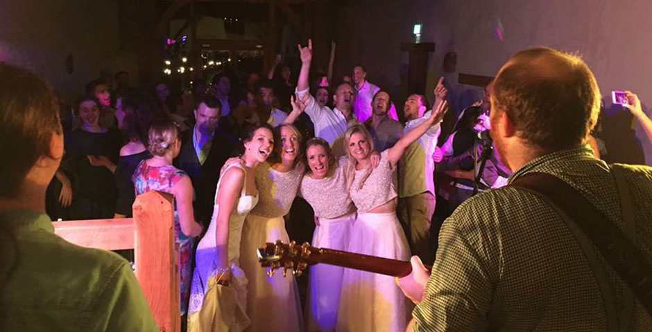 Bride and her maids cheer in front of the band