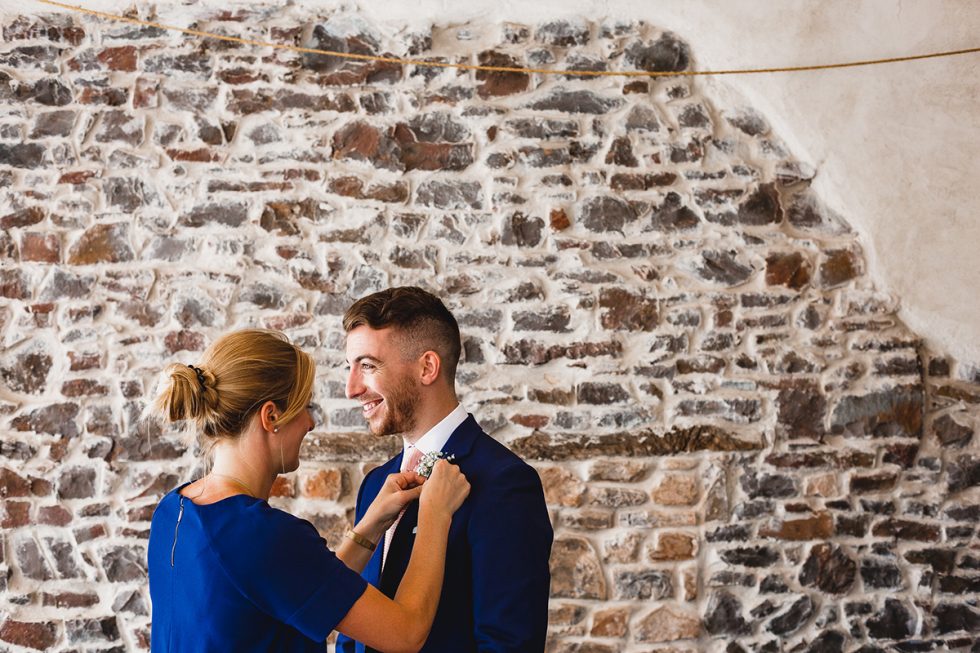 Rosie attaching buttonhole | How Photography